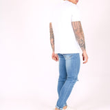 Logan Skinny Stretch Jeans In Light Stonewash With Ripped Knee - Liquor n Poker